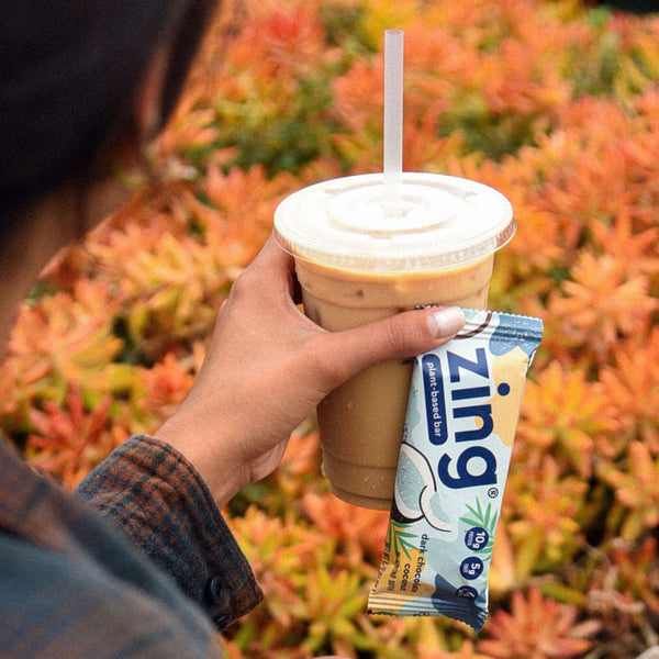 fall time cup of iced coffee and a dark chocolate coconut zing plant-based bar