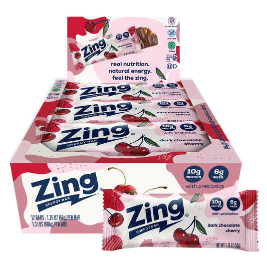 A box of Zing Energy Bar snack bars in cherry flavor, with several individual bars displayed in front on a clean white background.