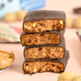 Stack of chocolate-covered energy bars with a blurred background