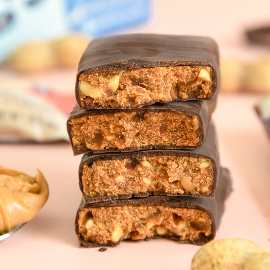 Stack of chocolate-covered energy bars with a blurred background