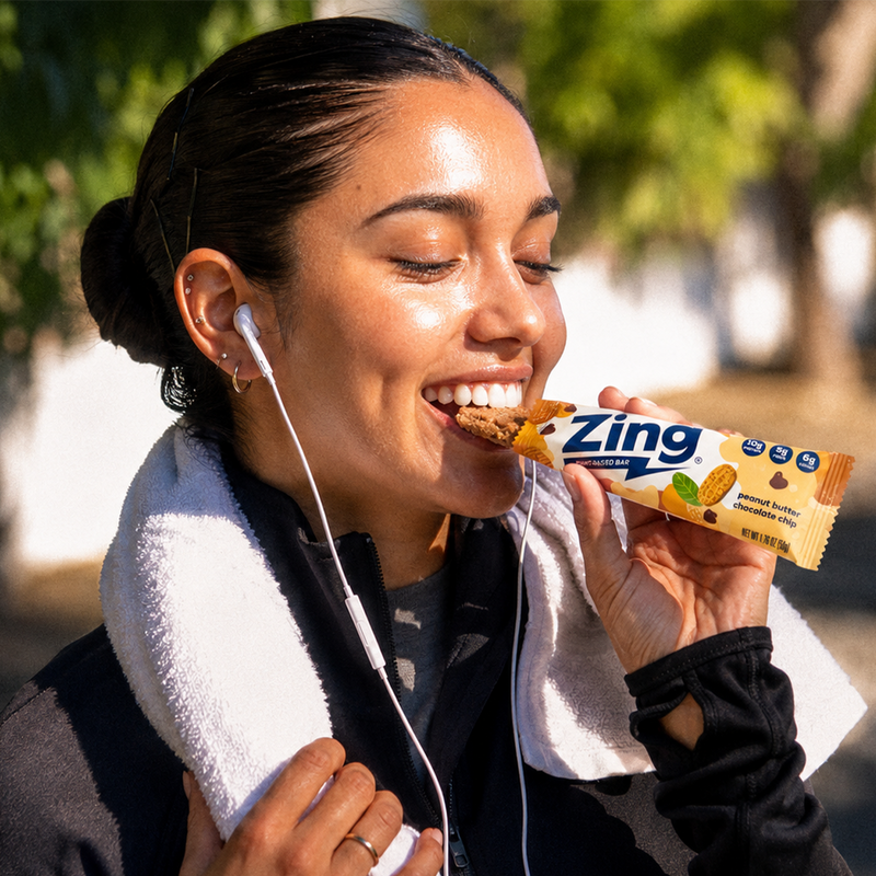 gym girl eating zing bar